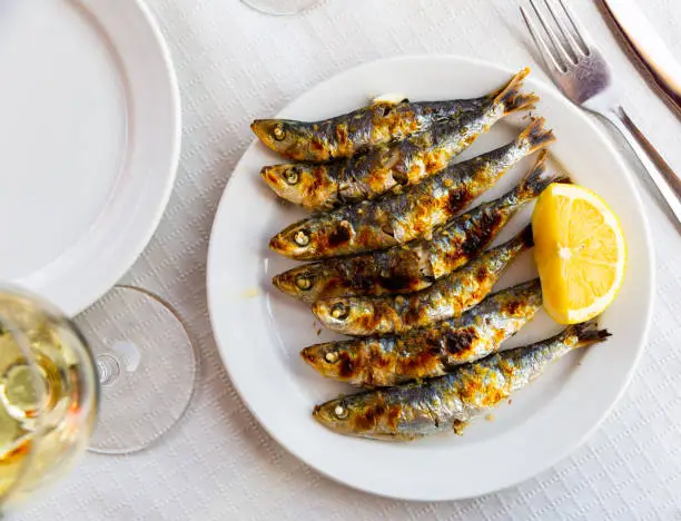 Photo of Espeto de sardinas with slice of lemon