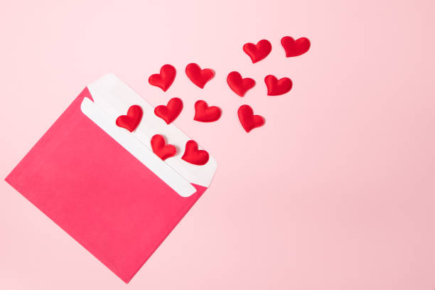 istock Envelope with greeting card for valentine's day. Romantic holiday concept. Hearts on a pink background. 1296227768