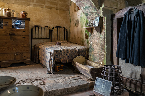 Matera, Italy, Aug, 2020 – Interior of a traditional cave house in Matera. Reconstruction of how people lived in that house