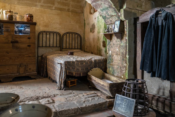 Interior of a traditional cave house in Matera, Basilicata, Italy Matera, Italy, Aug, 2020 – Interior of a traditional cave house in Matera. Reconstruction of how people lived in that house murge photos stock pictures, royalty-free photos & images