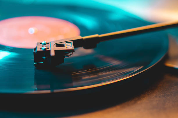 istock Cinemagraph loop vinyl record player turntable with its stylus running along music plate. Neon light. Retro-styled spinning record vinyl player. Close up 1296228897