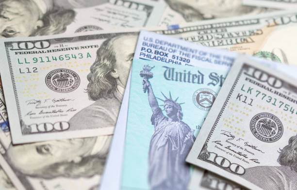 istock United States IRS Check and Envelope Resting on Money 1296230176