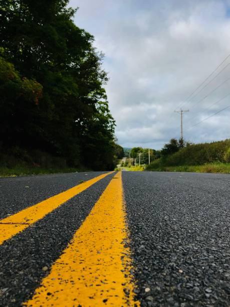 istock View from the yellow lines, scenic empty road. 1296234176