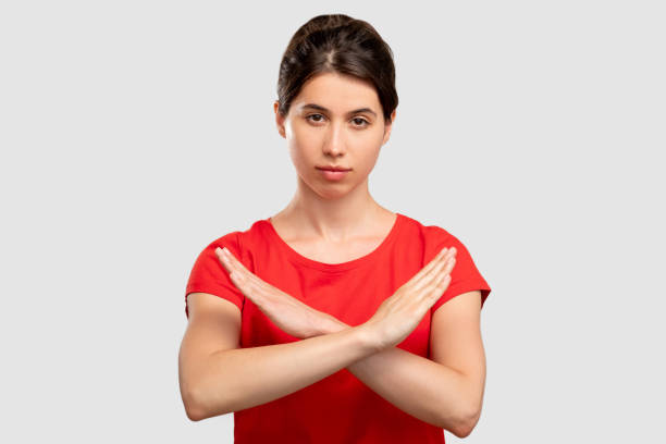 istock stop sign forbidden gesture woman crossing hands 1296235106