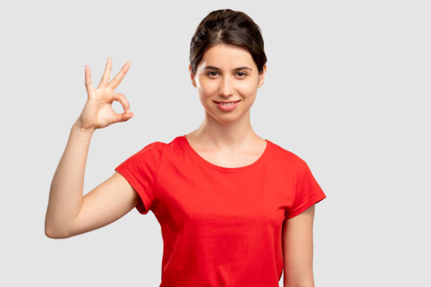 istock ok gesture approval sign happy woman 1296235107