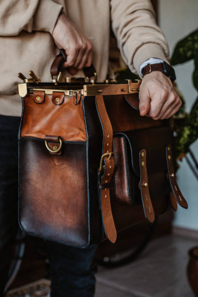 istock Business man holding elegant brown leather briefcase. 1296235372