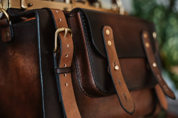 istock Business man holding elegant brown leather briefcase. 1296235385