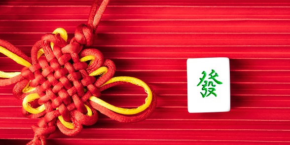 Chinese New Year Ornament. Mahjong with Fortune on red background,  Happy New Chinese Year. copy space, flat lay.