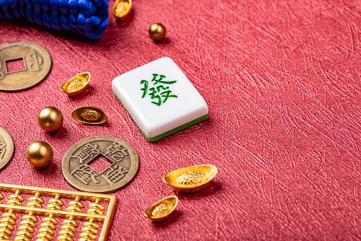 Chinese New Year Ornament. Auspicious artificial products on red background,  Happy New Chinese Year. Chinese text: Make a fortune and money. copy space, flat lay.