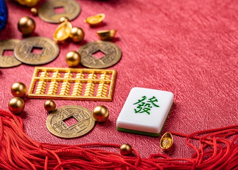 Chinese New Year Ornament. Auspicious artificial products on red background,  Happy New Chinese Year. Chinese text: Make a fortune and money. copy space, flat lay.