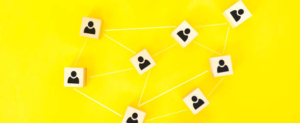 istock Organization structure, team building, recruitment, business management and human resources concepts. Person icons on wooden cubes linked to each other. 1296237191