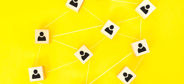 istock Organization structure, team building, recruitment, business management and human resources concepts. Person icons on wooden cubes linked to each other. 1296237193