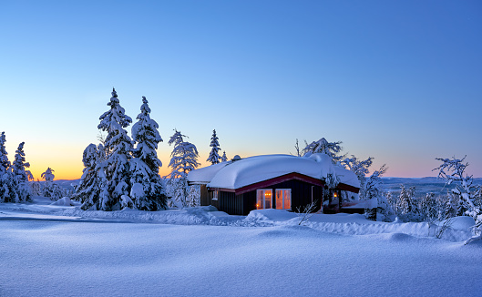 Simple cabin after heavy snowfall in the Norwegian mountains.