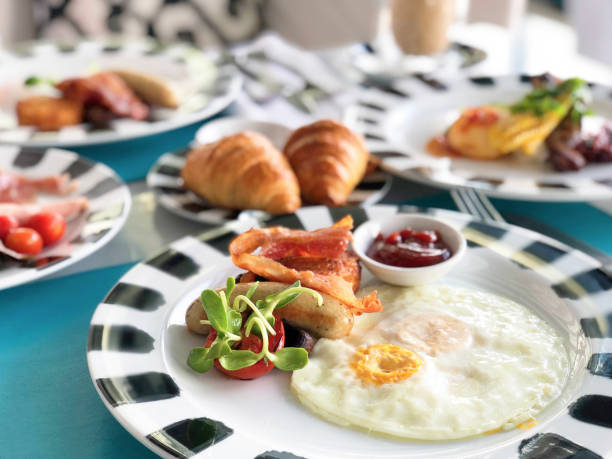 istock Delicious breakfast served with coffee, orange juice, egg, ham, bacon rolls at the luxury hotel 1296237445