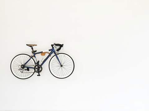Vintage bicycle hanging on white wall for decoration