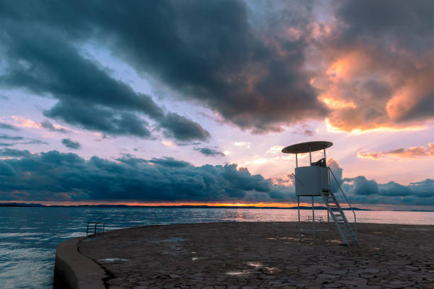istock Lifeguard observation tower on the beach at sunset 1296243626
