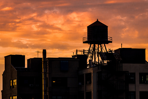 Silhouette of buildings and a water tower in Brooklyn, NY. USA