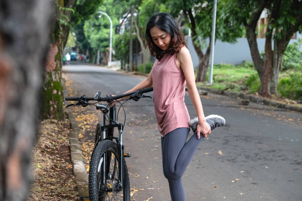 istock Asian woman stretching before cycling 1296244796