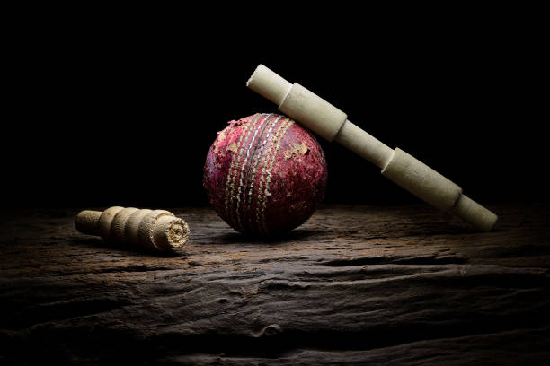Cricket ball and wickets bails still life close-up Cricket ball and wickets bails still life close-up on a highly texture wooden surface. Stock cricket stump photos stock pictures, royalty-free photos & images