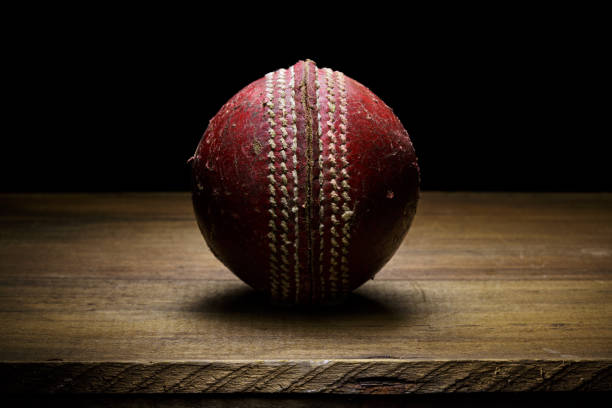 Leather Cricket ball close-up on a wooden surface