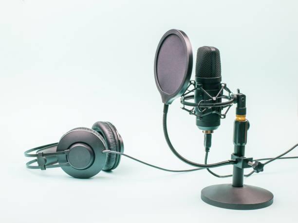 istock Condenser microphone and wired headphones on a blue background. 1296252464