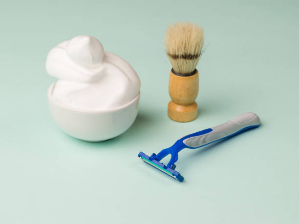 istock Plastic disposable razor, foam and a shaving brush for shaving. 1296252472