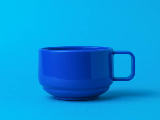 istock Blue cup for tea or coffee on a blue background. 1296252480