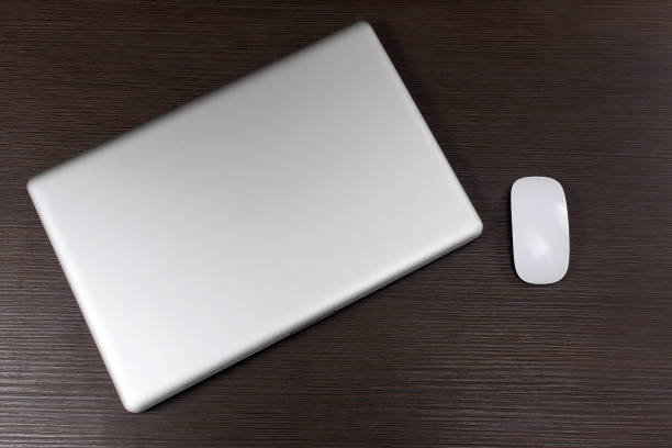 istock Laptop and mouse on wooden table 1296253667