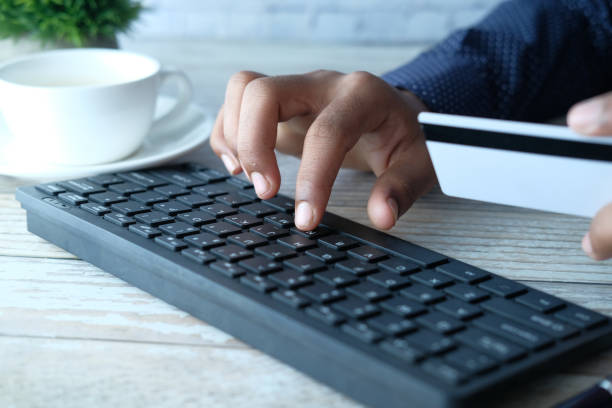 istock man hands holding credit card and using laptop shopping online 1296254564