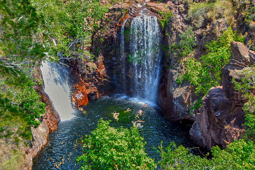 Two waterfalls and a billabong with swimmers in the Northern Territory of Australia