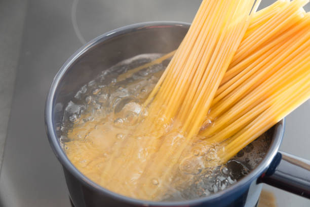 istock Cooking Bucatini Pasta in pot on electric stove. 1296255575