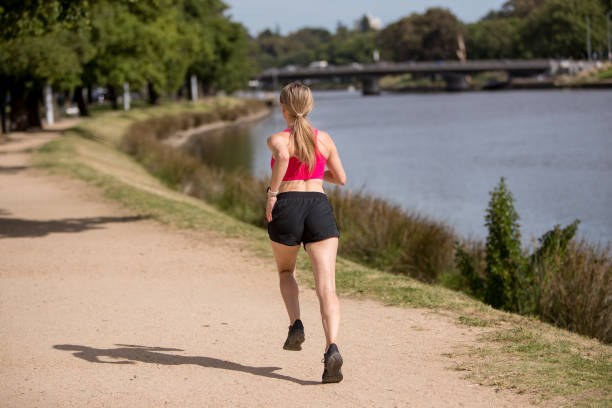 Young Woman Jogging by the Yarra River