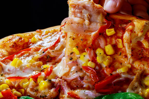Hands taking pizza slices close up selective focus view from wooden table