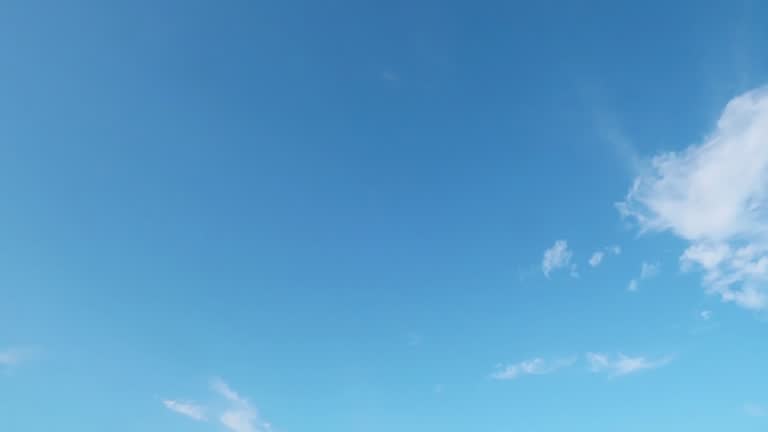 Beautiful sunny clear blue sky background with building motion white cloud