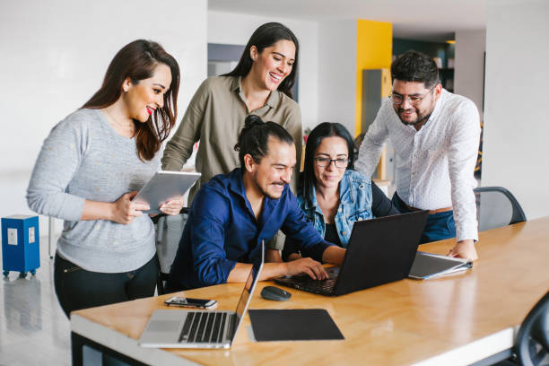 istock Group of latin business people working together as a teamwork while sitting at the office desk in a creative office in Mexico city 1296262028
