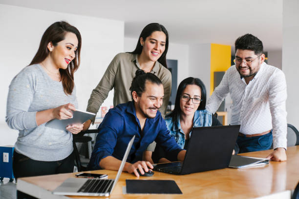 Group of latin business people working together as a teamwork while sitting at the office desk in a creative office in Mexico city stock photo