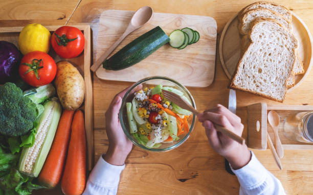 istock a female chef cooking fresh mixed vegetables salad in kitchen 1296262904