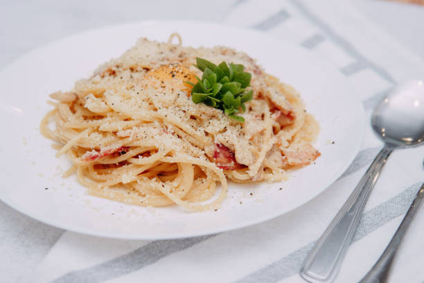 istock Spaghetti Carbonara on a white plate on the table. Home-made food 1296263826