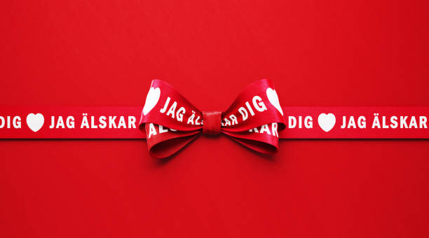 istock I Love You ( Jag Alskar Dig in Swedish ) Written Red Ribbon over Red Background 1296268131