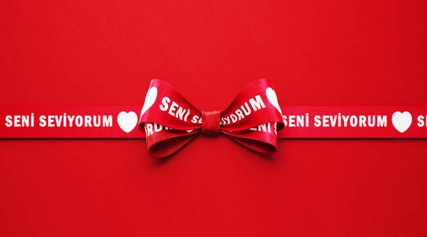 istock I Love You ( Seni Seviyorum in Turkish ) Written Red Ribbon over Red Background 1296268194