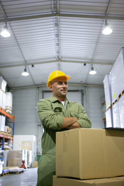 istock Positive blue collar worker in yellow hardhat and overall 1296271152