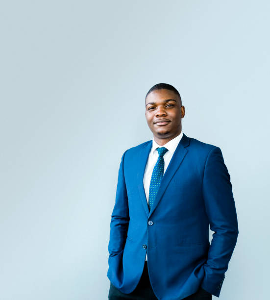 istock Confident male professional with hands in pockets 1296271172