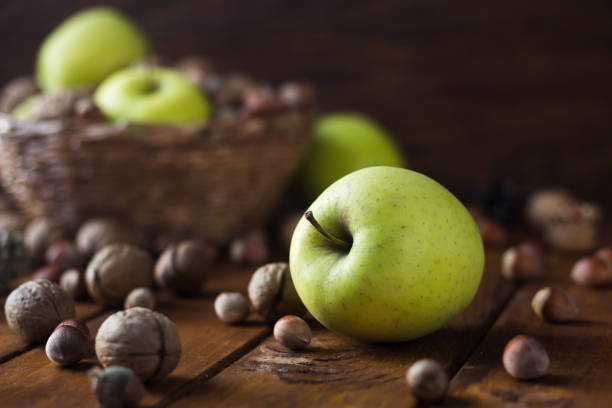 istock walnuts with green apples mixed with a wicker basket 1296271184