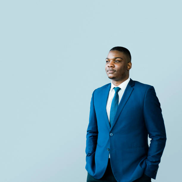 Thoughtful male CEO standing with hands in pockets
