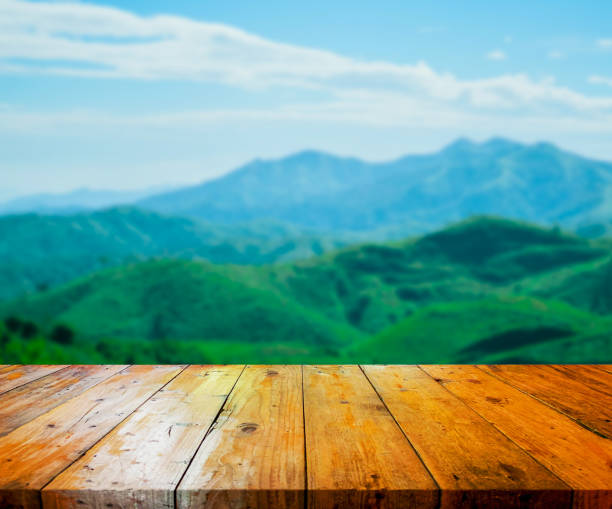 istock Wooden table and view of forest, mountain, sky 1296271241
