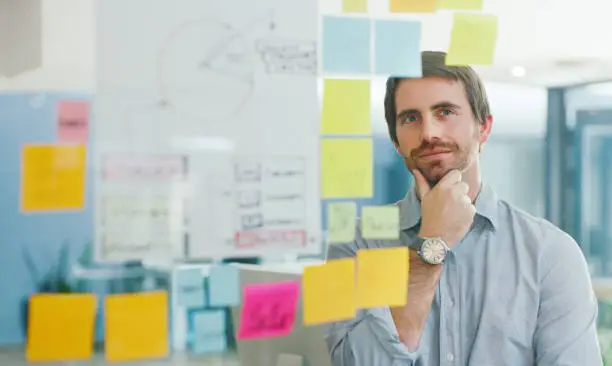 Shot of a young businessman having a brainstorming session in a modern office