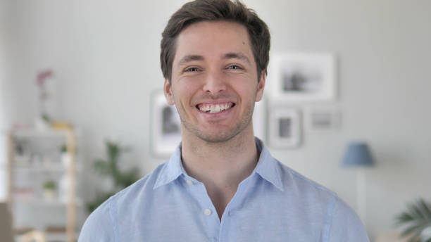 istock Portrait of Smiling Handsome Young Man Looking at Camera 1296271557