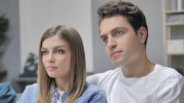 istock Close Up of Young Couple Looking at Camera 1296271578