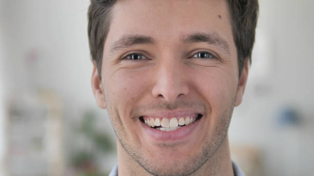 istock Face Close Up of Smiling Handsome Young Man 1296271779