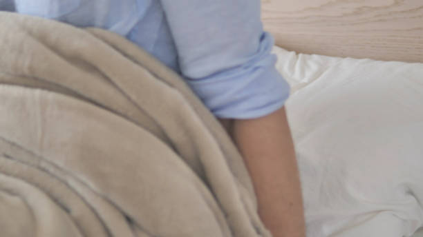 istock Young Man Waking Up after Sleeping, Leaving in Bed 1296271968